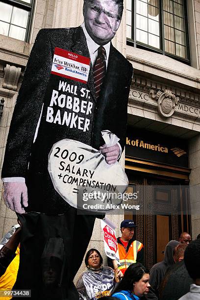 Activists hold a cardboard cutout of CEO of Bank of America Brian Moynihan during a protest to call for Wall Street reform and bank accountability...