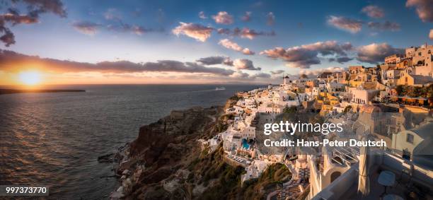 sun setting over oia, greece. - deutsch stock pictures, royalty-free photos & images