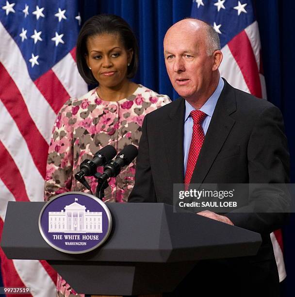 First Lady Michelle Obama listens alongside David Mackay, chair of the Healthy Weight Commitment Foundation and CEO of Kellogg Company, during an...