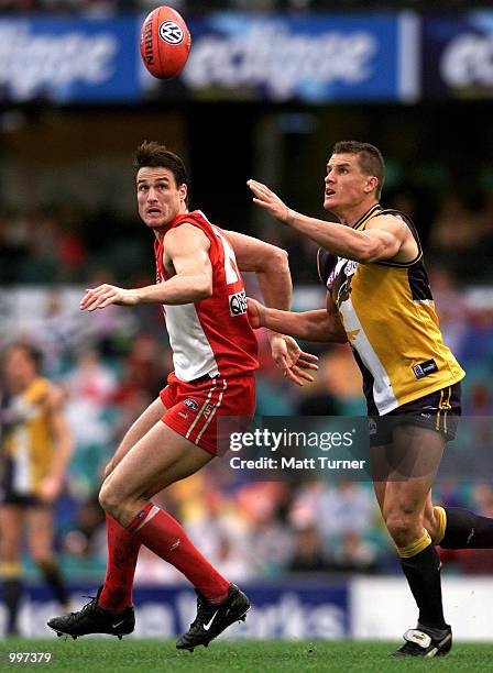 Jason Ball of the Swans competes with Glen Jakovich of the Eagles during the AFL round 17 match between the Sydney Swans and the West Coast Eagles...