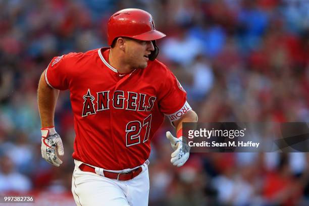 Mike Trout of the Los Angeles Angels of Anaheim runs to first base after hitting a single during the first inning of a game against the Seattle...