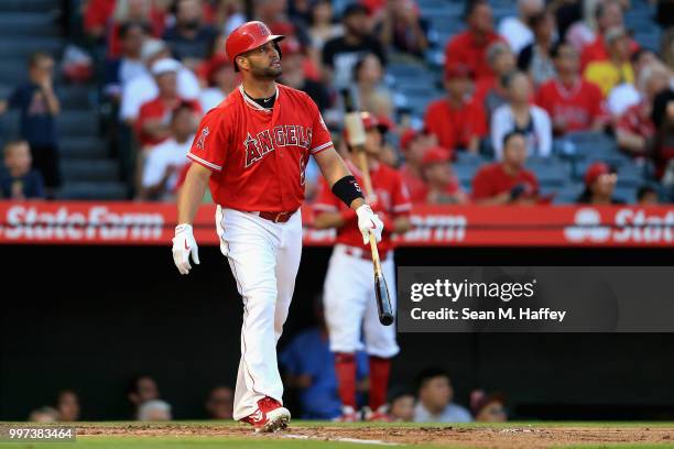 Albert Pujols of the Los Angeles Angels of Anaheim watches his two-run homerun during the first inning of a game against the Seattle Mariners at...