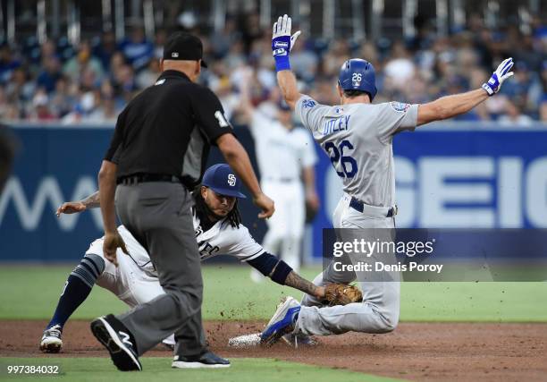 Chase Utley of the Los Angeles Dodgers is tagged out by Freddy Galvis of the San Diego Padres as he tries to steal second base during the third...