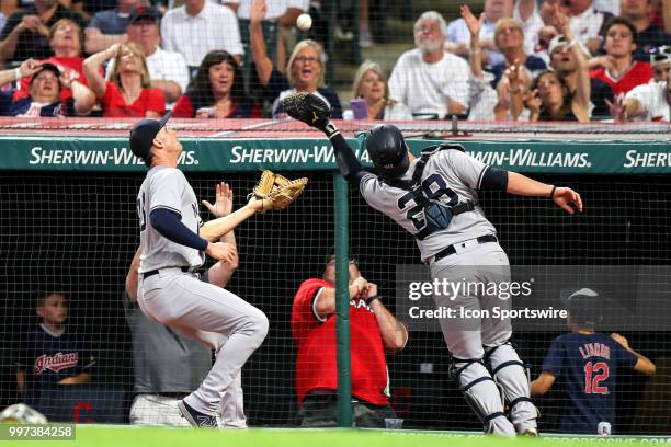 New York Yankees catcher Austin Romine catches a foul ball hit by Cleveland Indians designated hitter Edwin Encarnacion for an out as New York...