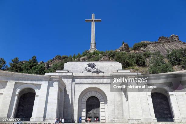 July 2018, Spain, El Escorial: A 155 metres high and 44 metres wide concrete cross stands on the top of the Risco de la Nava behind the Benedictine...