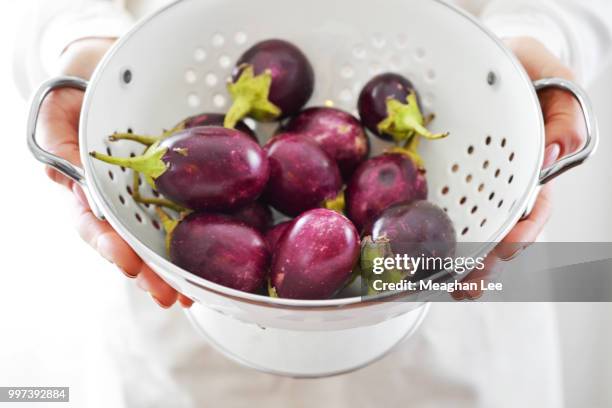 baby eggplant in white strainer - white eggplant stock pictures, royalty-free photos & images