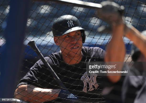 Aaron Judge of the New York Yankees watches from behind the batting cage during batting practice before the start of MLB game action against the...