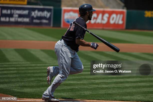 Edwin Encarnacion of the Cleveland Indians runs to first base after hitting an RBI single against the Oakland Athletics during the first inning at...