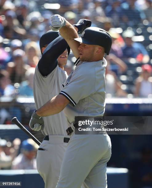 Brett Gardner of the New York Yankees is congratulated by Aaron Judge after hitting a solo home run in the first inning during MLB game action...