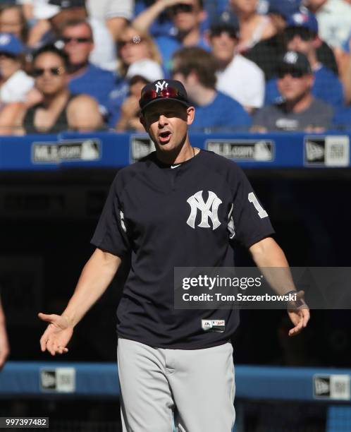 Manager Aaron Boone of the New York Yankees comes out of the dugout to argue a call in the third inning during MLB game action against the Toronto...