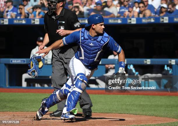 Luke Maile of the Toronto Blue Jays chases a passed ball to the backstop in the third inning during MLB game action against the New York Yankees at...