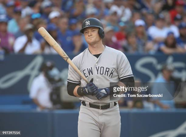 Clint Frazier of the New York Yankees reacts after being called out on strikes in the sixth inning during MLB game action against the Toronto Blue...
