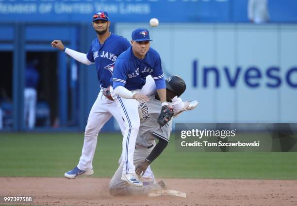Aledmys Diaz of the Toronto Blue Jays collides with Didi Gregorius of the New York Yankees as Gregorius arrives safely at second base but Diaz throws...