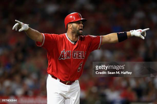Albert Pujols of the Los Angeles Angels of Anaheim reacts after hitting a single during the fifth inning of a game against the Seattle Mariners at...