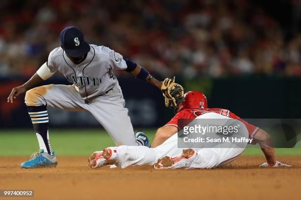 Mike Trout of the Los Angeles Angels of Anaheim steals second base under the tag of Dee Gordon of the Seattle Mariners during the fifth inning of a...