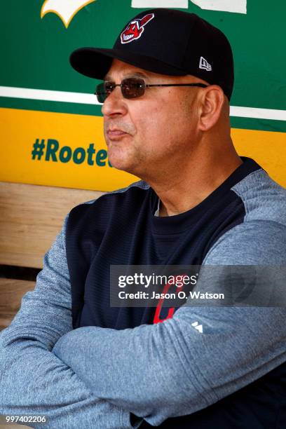 Terry Francona of the Cleveland Indians sits in the dugout before the game against the Oakland Athletics at the Oakland Coliseum on July 1, 2018 in...