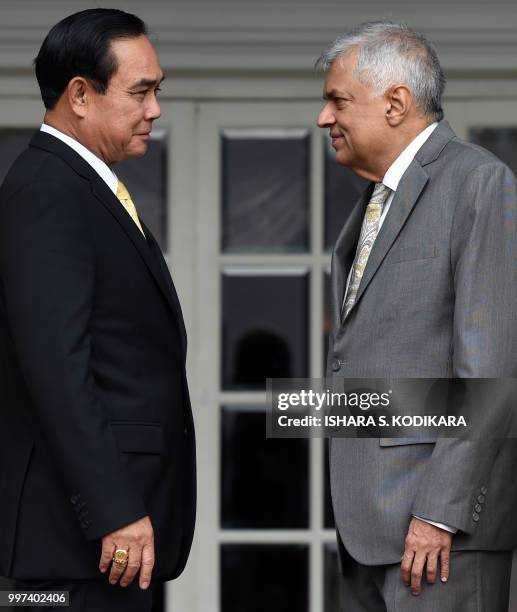 Sri Lanka's Prime Minister Ranil Wickremesinghe and Thailand's Prime Minister Prayut Chan-O-Cha attend a meeting at the prime minister's office in...