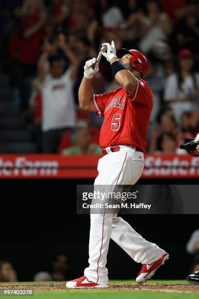 Albert Pujols of the Los Angeles Angels of Anaheim reacts after hitting a solo homerun during the sixth inning of a game against the Seattle Mariners...