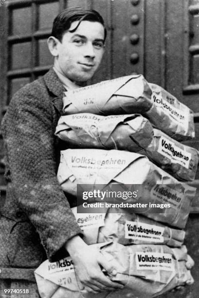 Petition for a Referendum. The picture shows a man carrying the ballots for the petition for the retirement arrangement in Austria. Photograph....