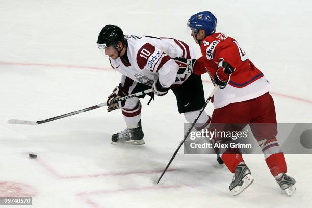 Lauris Darzins of Latvia is challenged by Karel Rachunek of Czech Republic during the IIHF World Championship group F qualification round match...
