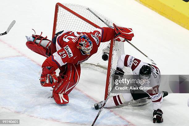 Goalkeeper Tomas Vokoun of Czech Republic is challenged by Martins Cipulis of Latvia during the IIHF World Championship group F qualification round...
