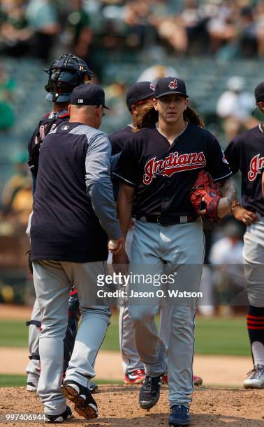 Mike Clevinger of the Cleveland Indians is relieved by manager Terry Francona during the seventh inning against the Oakland Athletics at the Oakland...
