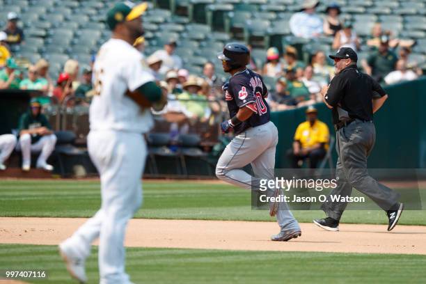 Edwin Encarnacion of the Cleveland Indians rounds the bases after hitting a home run off of Yusmeiro Petit of the Oakland Athletics during the...