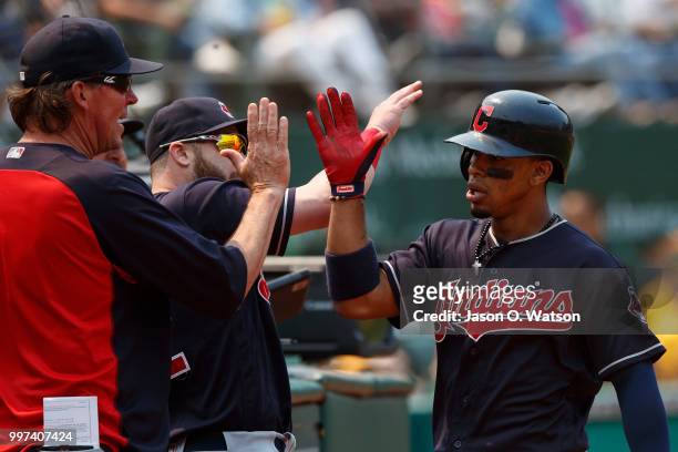 Francisco Lindor of the Cleveland Indians is congratulated by teammates after hitting a home run against the Oakland Athletics during the seventh...