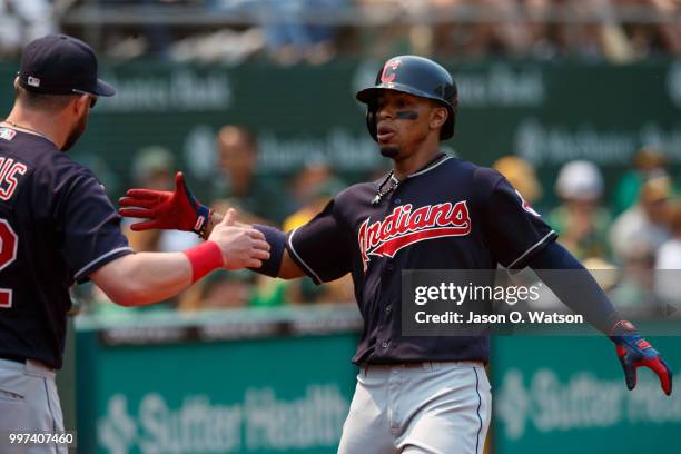 Francisco Lindor of the Cleveland Indians is congratulated by teammates after hitting a home run against the Oakland Athletics during the seventh...