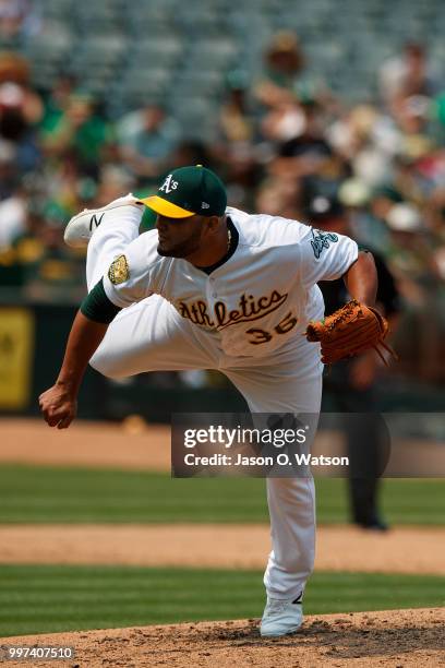 Yusmeiro Petit of the Oakland Athletics at bat against the Cleveland Indians during the sixth inning at the Oakland Coliseum on July 1, 2018 in...