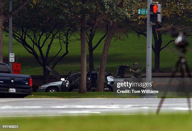 Member of the bomb squad gives a thumbs up after clearing a car with that contained a suspicious package at 1st and Constitution Ave., N.W., Friday