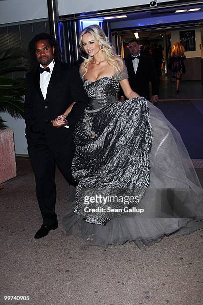 Former footballer Christian Karembeu and model Adriana Karembeu depart "Biutiful" Premiere at the Palais des Festivals during the 63rd Annual Cannes...