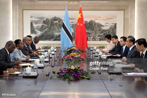 Botswana's Minister of International Affairs and Cooperation Unity Dow, second from left, listens as Chinese Foreign Minister Wang Yi, second from...