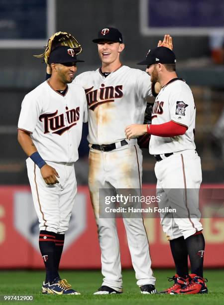 Eddie Rosario, Max Kepler and Robbie Grossman of the Minnesota Twins celebrate defeating the Tampa Bay Rays after the game on July 12, 2018 at Target...