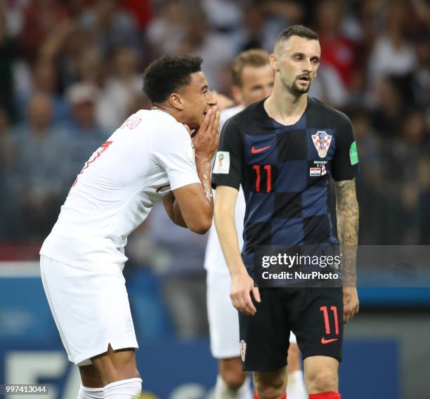Jesse Lingard of England with Marcelo Brozovic of Croatia react during the 2018 FIFA World Cup Russia Semi Final match between England and Croatia at...