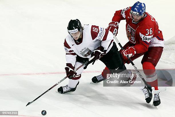 Kaspars Saulietis of Latvia is challenged by Petr Caslava of Czech Republic during the IIHF World Championship group F qualification round match...