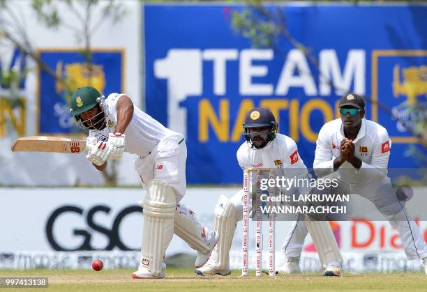 South Africa's Temba Bavuma plays a shot in front Sri Lanka's wicketkeeper Niroshan Dickwella and Angelo Mathews during the second day of the opening...