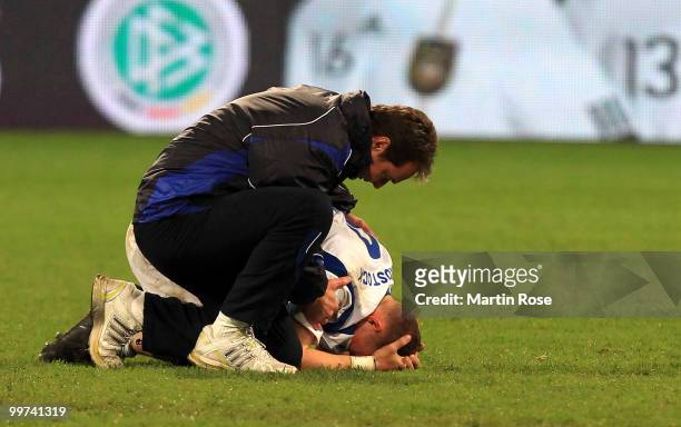 Marco Kostmann , head coach of Rostock comforts Enrico Kern of Rostock after the Second Bundesliga play off leg two match between Hansa Rostock and...