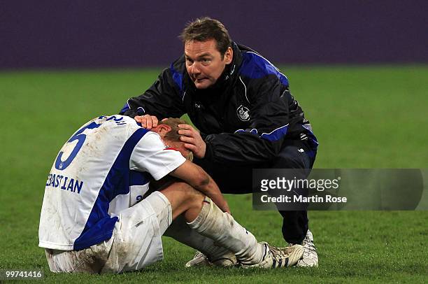 Marco Kostmann , head coach of Rostock comforts Tim Sebastian of Rostock after the Second Bundesliga play off leg two match between Hansa Rostock and...