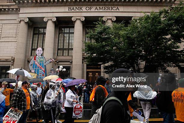 Activists protest to call for Wall Street reform and bank accountability May 17, 2010 in front of a Bank of America in Washington, DC. The march,...