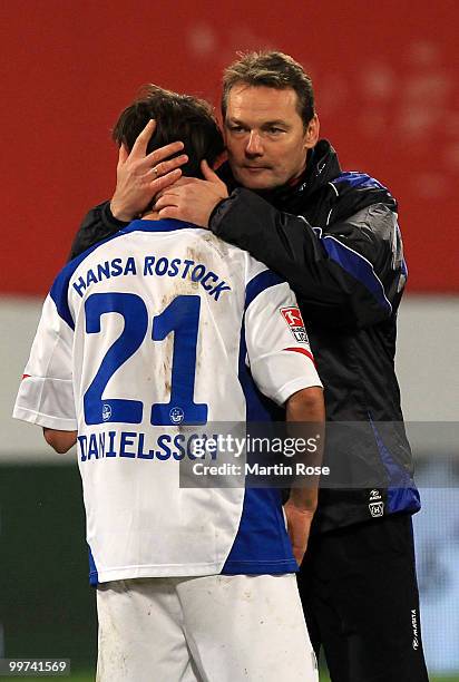 Marco Kostmann , head coach of Rostock comforts Helgi Valur Danielsson of Rostock after the Second Bundesliga play off leg two match between Hansa...