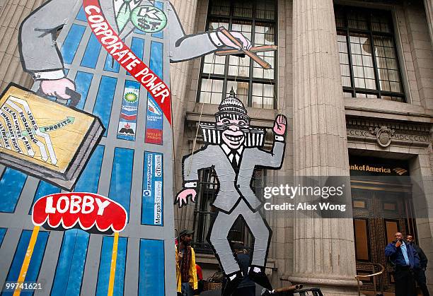 Activists protest to call for Wall Street reform and bank accountability May 17, 2010 in front of a Bank of America in Washington, DC. The march,...