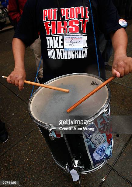 An activists hits a drum as he protests to call for Wall Street reform and bank accountability May 17, 2010 in front of a Bank of America in...