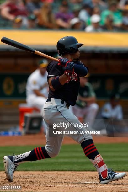 Francisco Lindor of the Cleveland Indians hits a double against the Oakland Athletics during the fifth inning at the Oakland Coliseum on July 1, 2018...