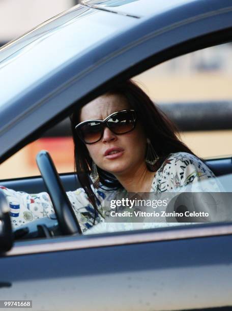 Actress Lindsay Lohan departs to attend Press Meeting aboard Lancia "Signora Del Vento" on May 17, 2010 in Cannes, France.