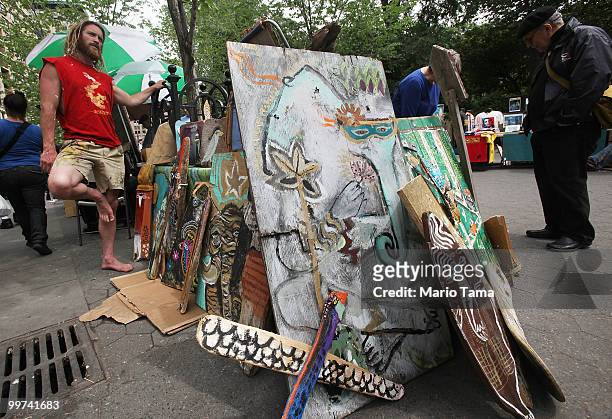 An artist who identified himself as Lloyd Bentley III hawks his artwork in Union Square May 17, 2010 in New York City. Mayor Michael Bloomberg's...