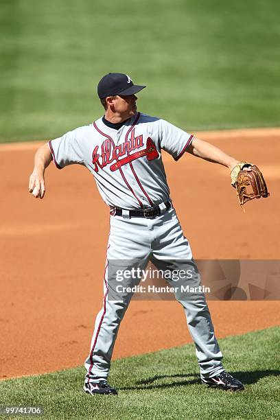 Third baseman Chipper Jones of the Atlanta Braves throws to first base during a game against the Philadelphia Phillies at Citizens Bank Park on May...