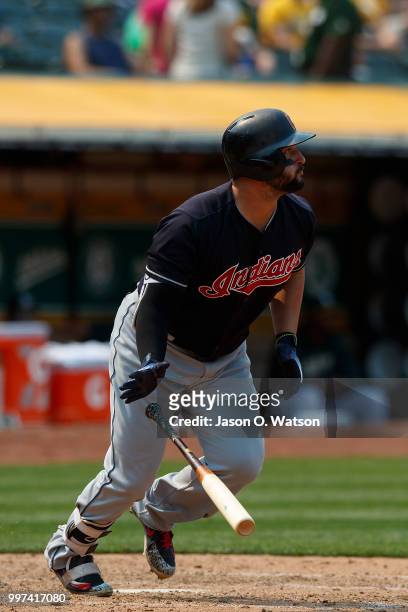 Yonder Alonso of the Cleveland Indians hits an RBI single against the Oakland Athletics during the eighth inning at the Oakland Coliseum on July 1,...