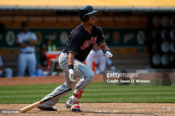 Michael Brantley of the Cleveland Indians hits a two run single against the Oakland Athletics during the eighth inning at the Oakland Coliseum on...