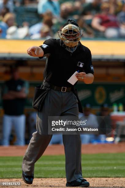 Umpire John Libka signals to the Cleveland Indians dugout during the eighth inning at the Oakland Coliseum on July 1, 2018 in Oakland, California....